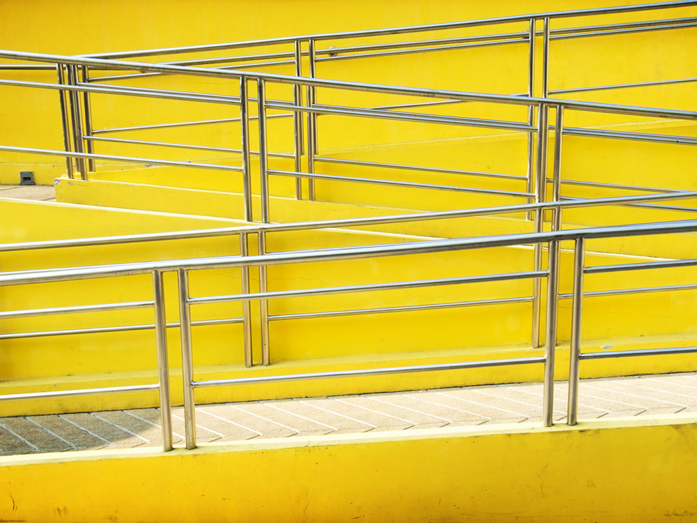 A yellow zig-zagging pedestrian ramp